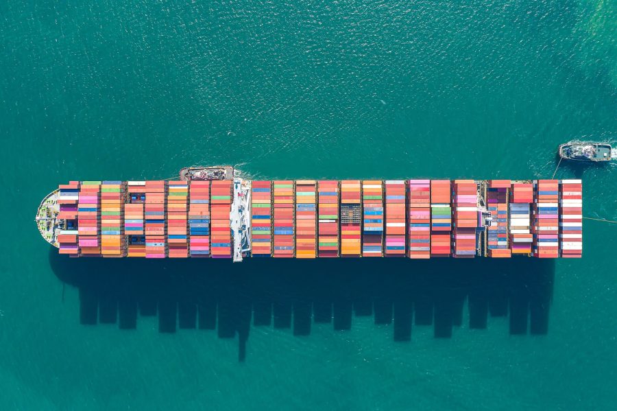 Aerial top view of cargo ship carrying container for import export goods  to customer,concept logistic and supply chain.