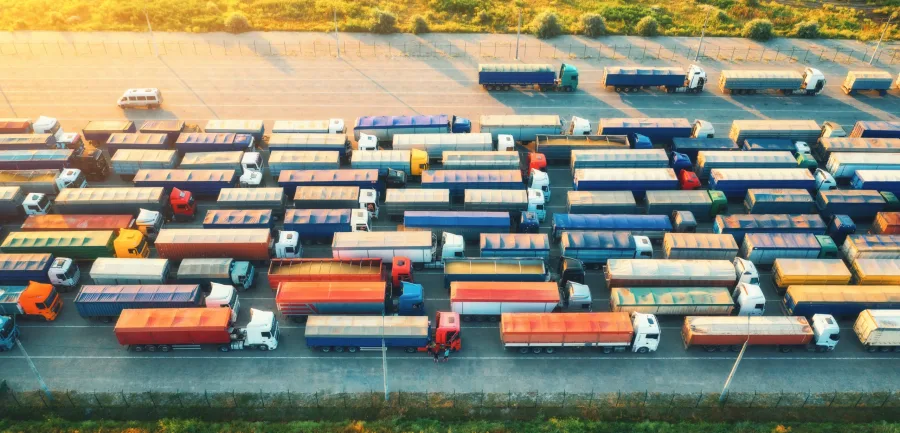 Aerial view of colorful trucks in terminal at sunrise in summer