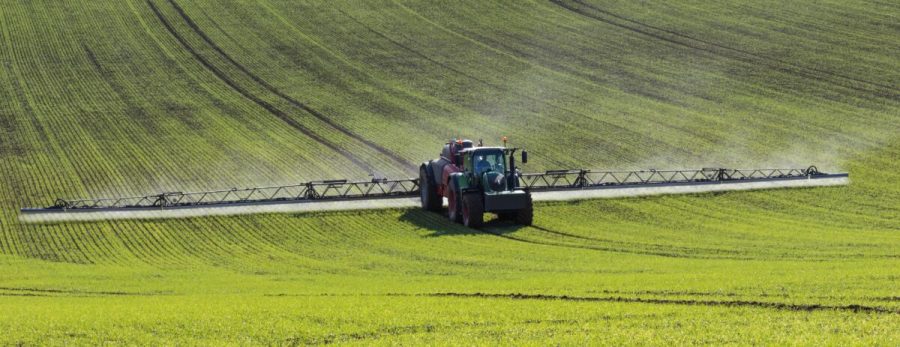 Agriculture - A farmer spraying fertilizer on his crops - North Yorkshire - England.