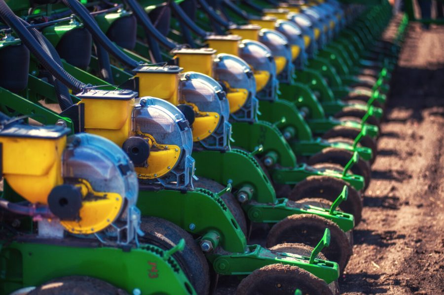 Tractor plowing farm field in preparation for spring planting.